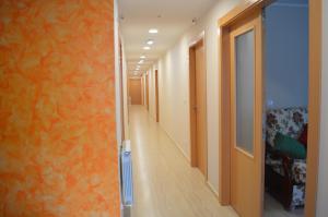 a hallway with orange walls and a long corridor at Hotel Las Terrazas in Tazones