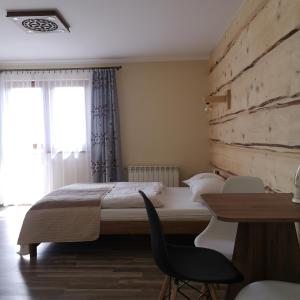 a hotel room with two beds and a table at Janickowa Ostoja in Zakopane