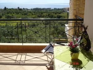 einen Tisch und einen Stuhl auf einem Balkon mit Aussicht in der Unterkunft Sofia Luxury Maisonettes in Nikiti