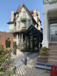 a large building with a store in front of it at Villa Augeval Hôtel de charme & Spa in Deauville