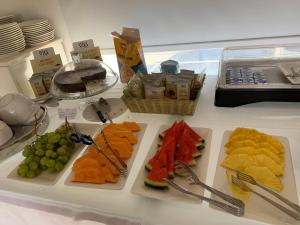 a table with several plates of food on it at Ganimede Hotel in Sperlonga