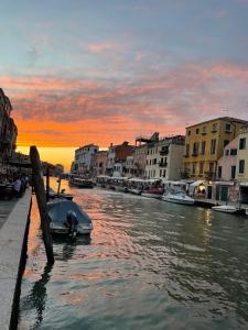 a boat is docked in a canal at sunset at Ca' Bonfadini Historic Experience in Venice
