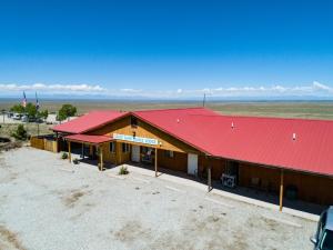a red brick building with a red roof at Great Sand Dunes Lodge in Mosca