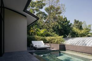 a house with a swimming pool and a patio at Capella Singapore in Singapore