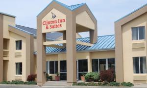 a large building with a sign on the front of it at Clinton Inn & Suites in Port Clinton