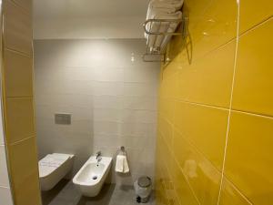 a bathroom with a sink and a toilet at Torre del mare Rooms in Bergeggi