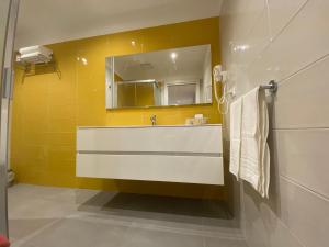 a bathroom with a sink and a mirror at Torre del mare Rooms in Bergeggi