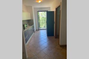 a kitchen with a tiled floor and a doorway at Casa Vacanza Azzolino in Grottazzolina +12 photos