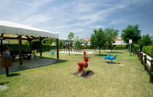 a park with a playground with a play equipment at Villaggio Teodorico in Punta Marina