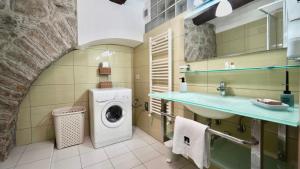 ein Badezimmer mit einem Waschbecken und einer Waschmaschine. in der Unterkunft ChSuite & PrivateParking - Corso 18 Agosto - Apartment in Potenza