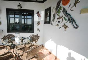 a dining room with a table and some butterflies on the wall at Finca el Volcan in Mácher