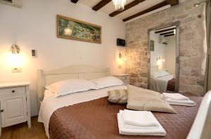 ein Schlafzimmer mit einem großen Bett und einem Spiegel in der Unterkunft Villa Carrara in Trogir