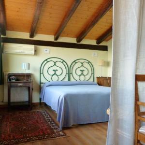 a bedroom with a blue bed and a wooden ceiling at Villa Margherita in Anduins +38 photos