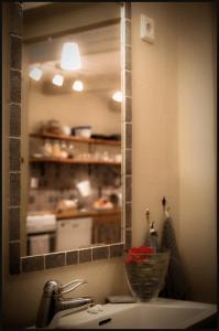 uma casa de banho com um lavatório com um espelho e uma cozinha em Bed & Breakfast Vinkille em Löderup