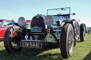 an old car is parked on the grass at Saddlers B&B in Funtington