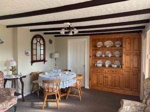 a dining room with a table and some chairs at Kirks Cottage in Cloghan