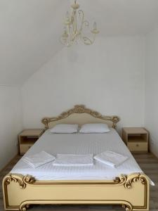 a bedroom with a gold bed with two night stands at Appartments near 7 km 5001155 in Odesa