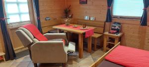 a room with a table and two chairs and a table and chairsuggest at Pfalz-Apartment Mein Chalet in Großkarlbach