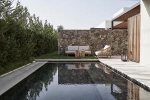 a swimming pool in the backyard of a house at The Olivar Suites in Mesongi