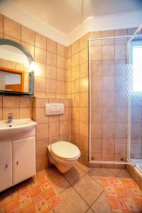 a bathroom with a toilet and a sink and a shower at Villa D&I in Vodice +13 photos