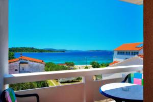 a balcony with a view of the ocean at Villa D&I in Vodice