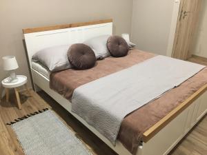 a bedroom with a bed with two pillows on it at Tokajský domček in Malá Tŕňa