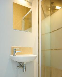 a bathroom with a sink and a glass shower at Vert Lodge Chamonix in Chamonix-Mont-Blanc