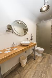 a bathroom with a sink and a toilet at Dēseles dzirnavas - Guest House in Embūte +69 photos