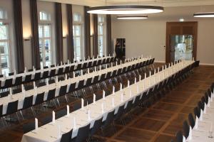 a row of tables and chairs in a room at Alte Brauerei Mertingen in Mertingen