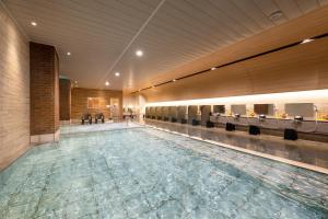 a large swimming pool in a building at Imagine Hotel & Resort in Hakodate +55 photos