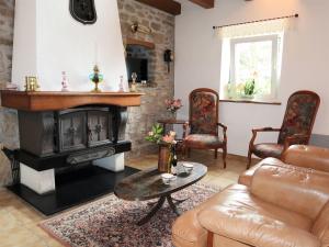 a living room with a couch and a fireplace at Holiday Home Ty Coz by Interhome in Guissény
