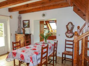 a dining room with a table and chairs at Holiday Home Ty Coz by Interhome in Guissény