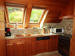 a kitchen with a sink and a microwave at Holiday Home Ty Coz by Interhome in Guissény +26 photos