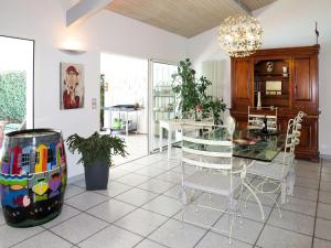 a dining room with a glass table and chairs at Holiday Home Villa Katy - ADS165 by Interhome in Andernos-les-Bains