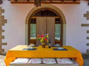 un tavolo giallo con un vaso di fiori sopra di Holiday Home Il Vallone by Interhome ad Aia Murata