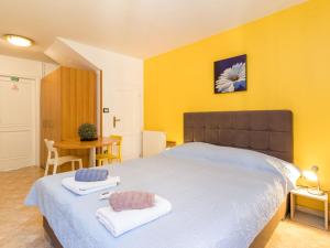 a bedroom with a large bed with two towels on it at Apartment Antonella & Napoletano-1 by Interhome in Umag