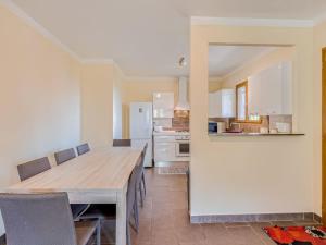 a kitchen with a large wooden table and chairs at Holiday Home A Mandria by Interhome in Ghisoni +18 photos