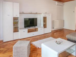 a living room with white cabinets and a television at Apartment Mirjana - LBN312-2 by Interhome in Ružići