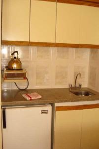a kitchen with a sink and a tea kettle on the counter at Colorina Las Leñas - Consorcio ATENAS in Las Lenas