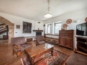 a living room with a couch and a table at Holiday Home Domus Magna-1 by Interhome in Povoletto