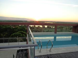 a view from the balcony of a house with a swimming pool at Rio Manso Apart Hotel in Victoria