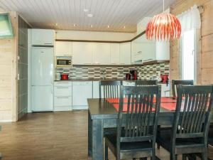 a kitchen with a table and chairs and a refrigerator at Holiday Home Lakka by Interhome in Sonka