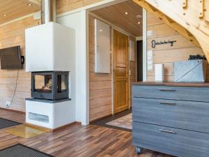 a living room with a fireplace in a house at Holiday Home Levin kaarna by Interhome in Levi