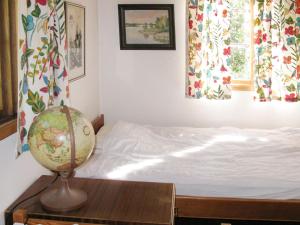 a bedroom with a bed and a globe on a table at Holiday Home Järnemåla Margaretetorp by Interhome in Valdemarsvik +6 photos