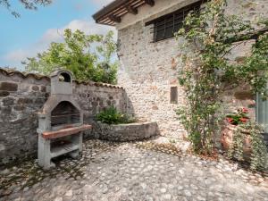 a brick building with an oven in front of it at Holiday Home Domus Magna-2 by Interhome in Povoletto