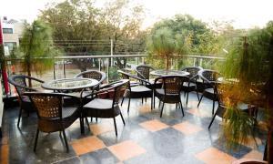 a group of tables and chairs on a patio at Hotel Jullundur 18 in Chandīgarh