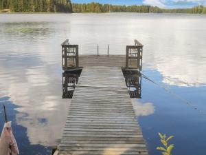 a dock in the middle of a body of water at Holiday Home Palkinniemi by Interhome in Putikko