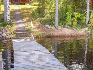 a wooden bridge over a body of water at Holiday Home Palkinniemi by Interhome in Putikko