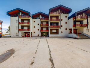 an empty parking lot in front of a building at Studio Le Hameau D002 by Interhome in Les Collons