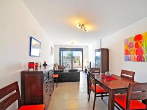 a dining room with a table and chairs and a couch at Apartment Isleta Marina-3 by Interhome in Jávea